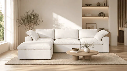A picture of a white sectional sofa in a bright, minimalist living room.