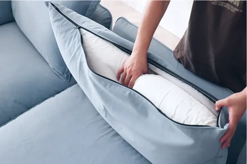 a picture of a person who is removing washable sofa covers