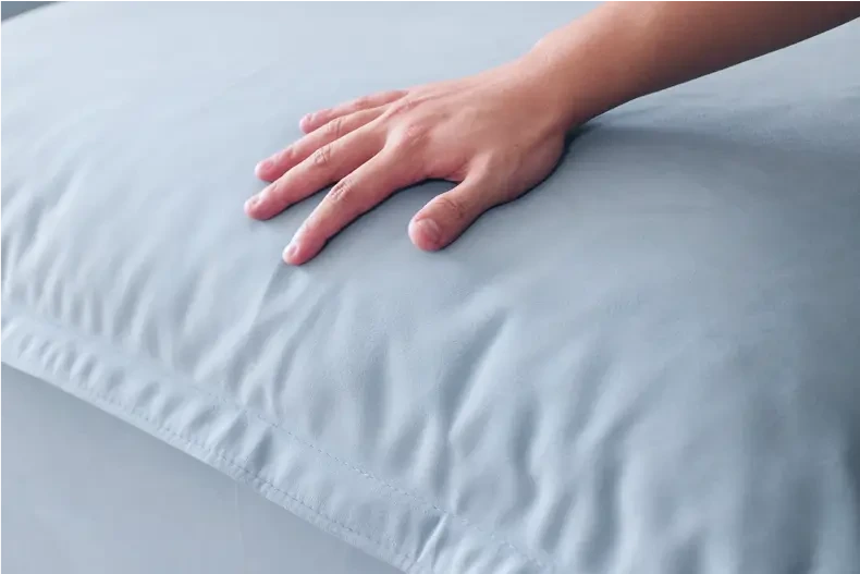 a picture of a person whose hands are on the sofa cover