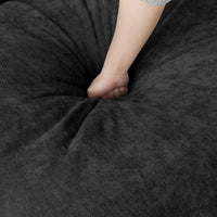 Seat cushion pressed by hand on a black Deluxe Cloud sofa